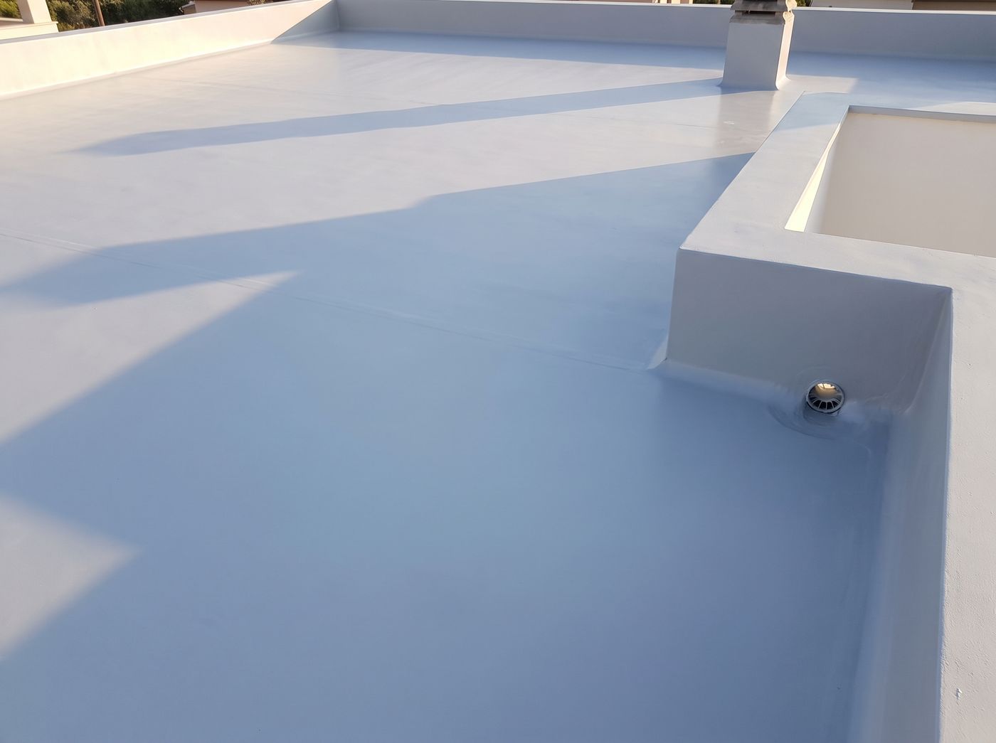 Completed terrace waterproofing with a seamless membrane and coved parapet junctions